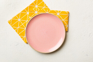 Sticker - Top view on colored background empty round pink plate on tablecloth for food. Empty dish on napkin with space for your design