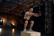 © Nomad_Soul - Athletic man doing step-up exercise on wooden box while training in sports club