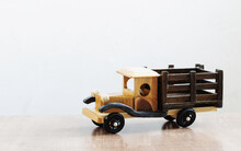 Vintage Wooden Homemade Car On Wooden Table On White Background
