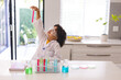 © Wavebreak Media - Hispanic boy analyzing chemical in test tube while doing scientific research at home