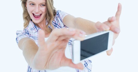 Poster - Caucasian woman taking a selfie from her smartphone against copy space on white background