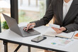 © Thitisak - Businesswoman hand using laptop sitting at office