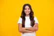 © Olena - Portrait of young teenage girl standing with crossed arms against yellow background with copy space.