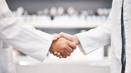 Wall Mural - Doctor, handshake and partnership in healthcare, medicine or trust for collaboration, unity or support at lab. Team of medical experts shaking hands in teamwork for agreement or success at pharmacy