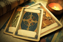 AI Illustration Of Tarot Cards With Candle And Book On Table