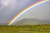 Fototapeta Tęcza - rainbow over the ,fields and mountains