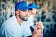 © Jesse Bettencourt/peopleimages.com - Baseball player, stadium dugout and sport training focus of a athlete looking at game. Summer sports, teamwork and workout of a person with softball group at professional event for outdoor exercise