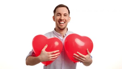 Portrait man posing with two red heart air balloon Saint Valentine's Day romantic holiday isolated