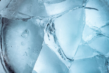 Wall Mural - Abstract ice background. Blue background with cracks on the ice surface