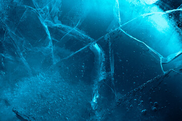 Wall Mural - Abstract ice background. Blue background with cracks on the ice surface