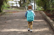 © New Africa - Little boy with backpack going to school, back view