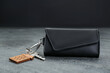 © New Africa - Leather case with key on grey table, closeup