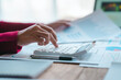 © R Photography - Close up bookkeepers working with balance sheet to analyze problems and find solutions to bringing develop business organization and company's stock market system. Using calculator
