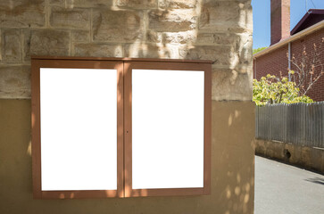 Blank white mockup template of 2 notice boards on wall at the corner of a European-style street with old houses in town. Empty background texture of posters, copy space for your design.