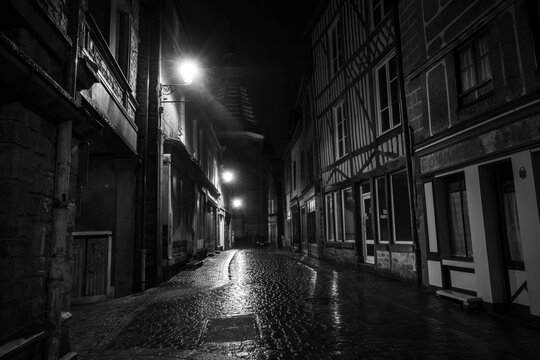 city of domfront in normandy, france during a rainy night
