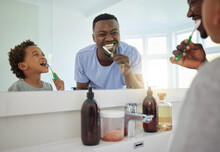 Dental, Brushing Teeth And Father With Son In Bathroom For Bonding, Morning Routine And Cleaning. Teaching, Self Care And Toothbrush With Black Man And Child At Home For Wellness, Fresh And Hygiene