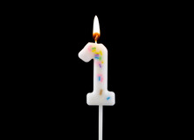 White Decorated Burning Birthday Candle Isolated On Black Background, Number 1