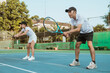 © Odua Images - male and female tennis players ready to receive the ball from the opponent while playing on the tennis court