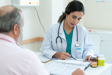 A female doctor examines the disease and gives advice on taking medication. for elderly patients receiving treatment