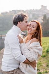 A loving couple hugging, a man gently kisses a woman