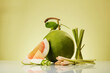 Bunches of lemongrass and pink pomelo (Citrus maxima) slices decorated on minimalist light background. Front view