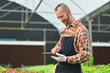 © Prathankarnpap - Successful farmer using tablet to record the growing of hydroponic vegetable in greenhouse. Business agriculture concept