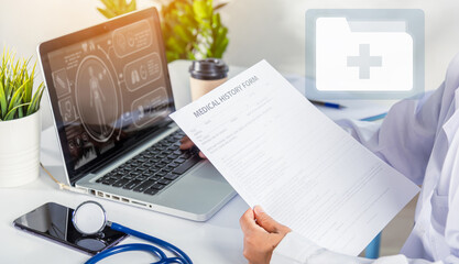 Doctor Day Concept. nurse woman in uniform with doctor stethoscope working typing information of patient prescription medical history form into laptop computer for record document data report