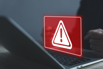 Wall Mural - businessman using laptop showing warning triangle and exclamation sign icon caution of dangerous pro