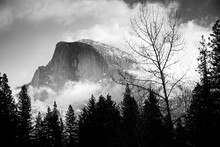 Yosemite's Half Dome In Black And White Is Covered In Snow.