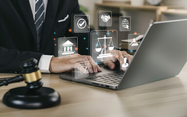 hand of the businessman or lawyer with legal services icon on the laptop screen for legal advice onl