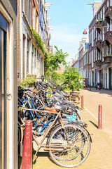 Wall Mural - Amsterdam, Netherlands - June 30, 2019: The historic city center of Amsterdam in the morning. Tweede Weteringdwarsstraat Street