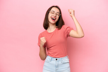 Wall Mural - Young Ukrainian woman isolated on pink background celebrating a victory