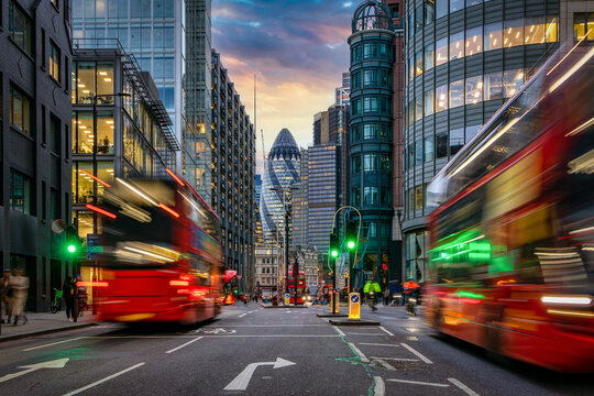 sunset at the city of london, england, with street traffic light trails and illuminated skyscrapers