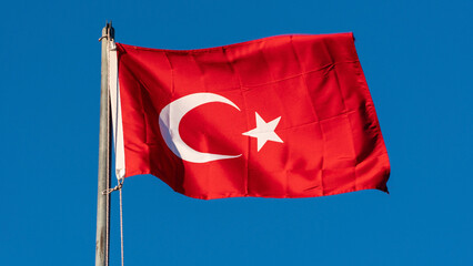 Turkish flag. Turkish flag and dramatic sunset sky. Turkish National holidays concept. 23 Nisan, 19 Mayis, 15 Temmuz, 30 Agustos, 29 Ekim concept. Selective focus. Motion blur due to wind.