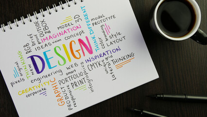 Wall Mural - Colorful DESIGN word cloud handwritten in notebook with espresso and pens on black wooden desk