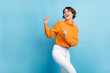 © deagreez - Photo portrait of attractive young woman dancing look empty space party wear trendy orange garment isolated on blue color background