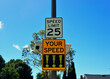A speed monitoring sign measures excessive speed and displays exclamation points