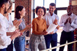 © Monkey Business - Colleagues Applauding Businesswoman Leading Team Meeting In Busy Multi-Cultural Office
