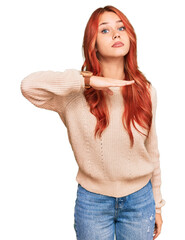 Sticker - Young redhead woman wearing casual winter sweater cutting throat with hand as knife, threaten aggression with furious violence