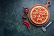 Tasty pepperoni pizza and cooking ingredients tomatoes basil on black concrete background. Top view of hot pepperoni pizza. With copy space for text. Flat lay. Banner, Pizza Margherita on black stone 