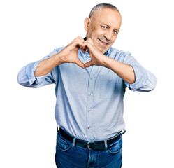 Wall Mural - Senior man with grey hair and beard wearing casual blue shirt smiling in love doing heart symbol shape with hands. romantic concept.