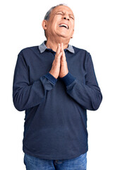 Poster - Senior handsome man wearing casual polo begging and praying with hands together with hope expression on face very emotional and worried. begging.