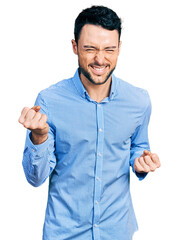 Sticker - Hispanic man with beard wearing casual business shirt very happy and excited doing winner gesture with arms raised, smiling and screaming for success. celebration concept.