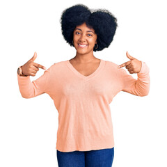 Poster - Young african american girl wearing casual clothes looking confident with smile on face, pointing oneself with fingers proud and happy.