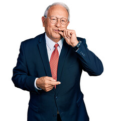 Canvas Print - Senior man with grey hair wearing business suit and glasses mouth and lips shut as zip with fingers. secret and silent, taboo talking