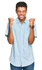 Sticker - Young handsome african american man wearing casual clothes excited for success with arms raised and eyes closed celebrating victory smiling. winner concept.