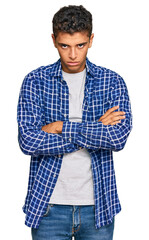 Poster - Young handsome african american man wearing casual clothes skeptic and nervous, disapproving expression on face with crossed arms. negative person.