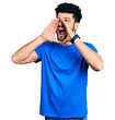 © Krakenimages.com - Young arab man with beard wearing casual blue t shirt shouting angry out loud with hands over mouth