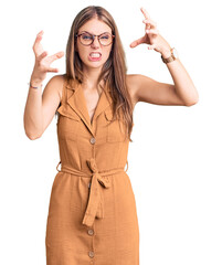 Wall Mural - Young beautiful blonde woman wearing casual clothes and glasses shouting frustrated with rage, hands trying to strangle, yelling mad