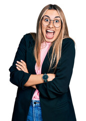 Canvas Print - Hispanic young woman with arms crossed gesture celebrating crazy and amazed for success with open eyes screaming excited.